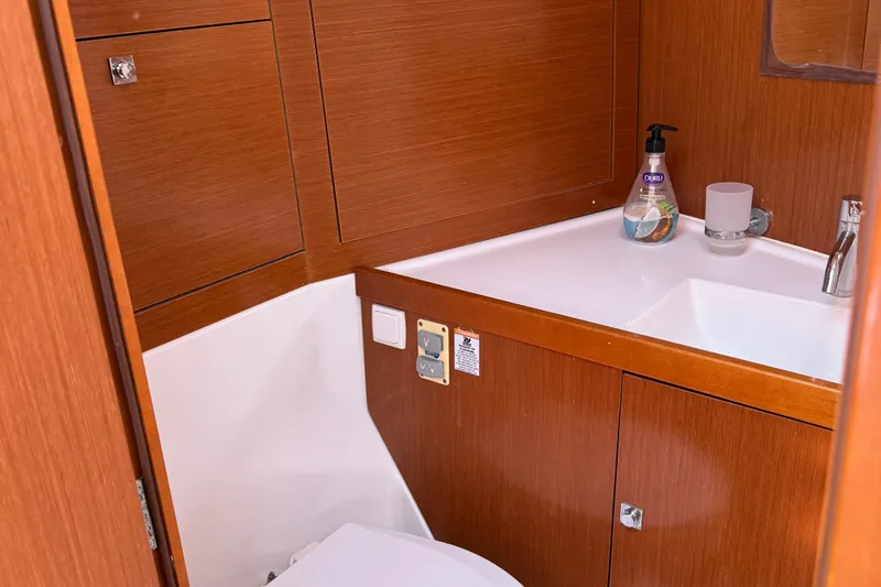 Smooth Yacht Photos Pics Beneteau Oceanis 45 2012 yacht bathroom with wooden cabinetry and modern sink.