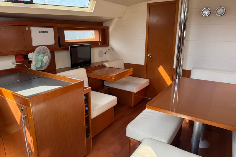 Smooth Yacht Photos Pics Interior of a 2012 Beneteau Oceanis 45 yacht with wood finish and seating area.