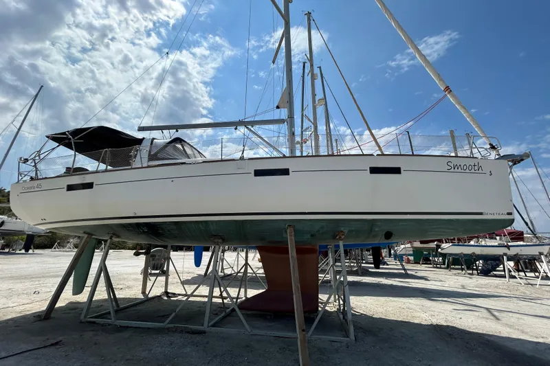 Smooth Yacht Photos Pics 2012 Beneteau Oceanis 45 sailboat on dry dock under a bright blue sky.