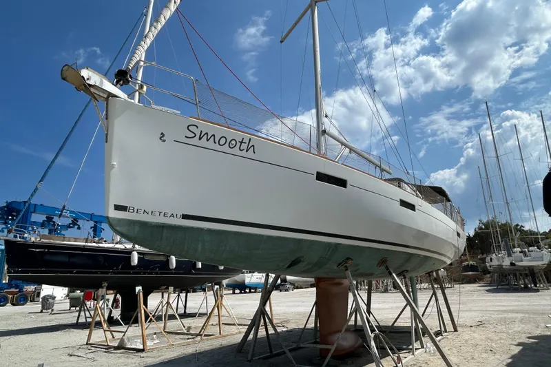 Smooth Yacht Photos Pics 2012 Beneteau Oceanis 45 sailboat on stands, clear sky background.