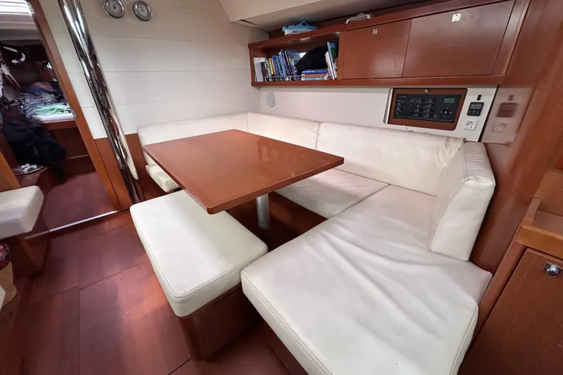 Smooth Yacht Photos Pics Interior of 2012 Beneteau Oceanis 45 yacht with cozy seating and wooden table.