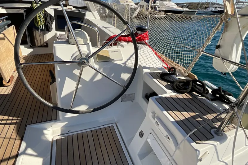 Smooth Yacht Photos Pics Cockpit of 2012 Beneteau Oceanis 45 sailboat with steering wheel and nautical equipment.