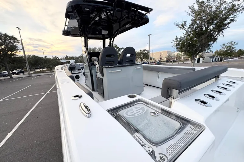  Yacht Photos Pics 2024 Sea Pro 292 DLX boat in parking lot, showcasing sleek design and spacious deck.