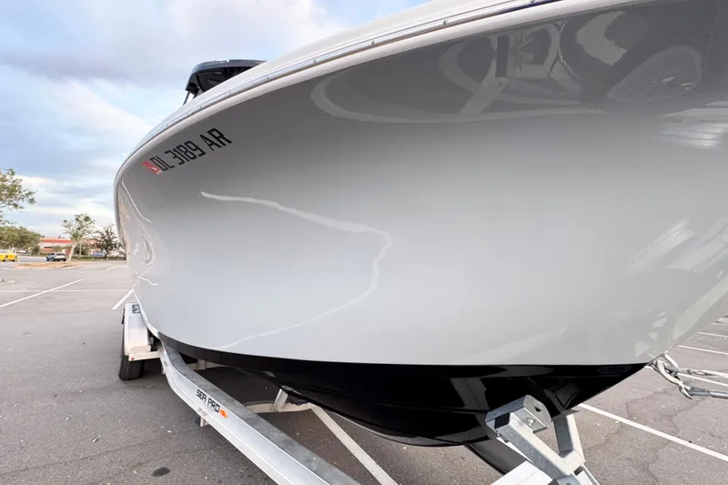  Yacht Photos Pics 2024 Sea Pro 292 DLX boat on trailer in parking lot.