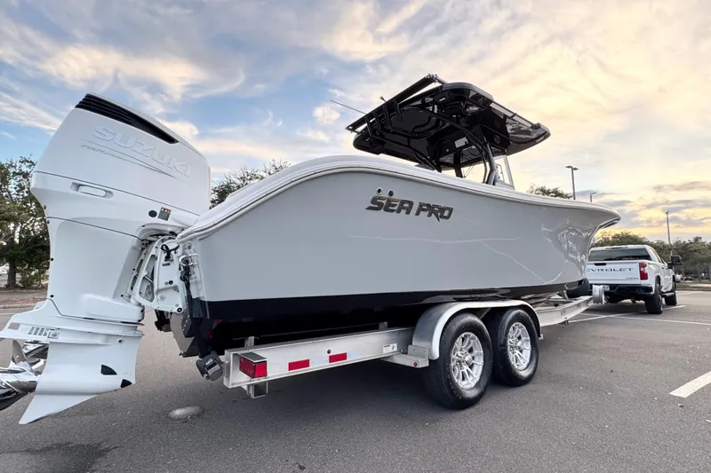 Yacht Photos Pics 2024 Sea Pro 292 DLX boat on trailer with Suzuki engine, parked outdoors.