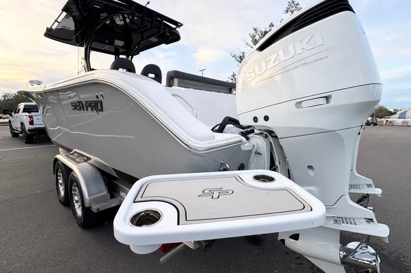  Yacht Photos Pics 2024 Sea Pro 292 DLX boat with Suzuki engine, parked on a trailer.