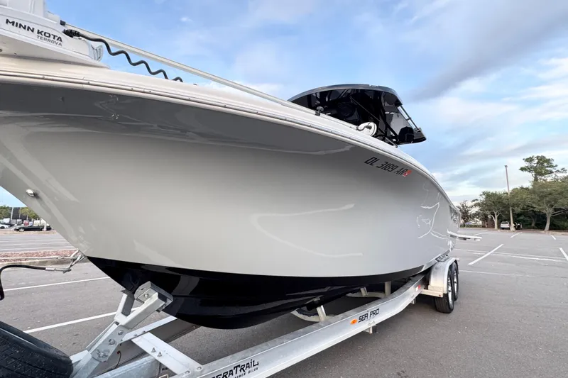  Yacht Photos Pics 2024 Sea Pro 292 DLX boat on trailer in parking lot.
