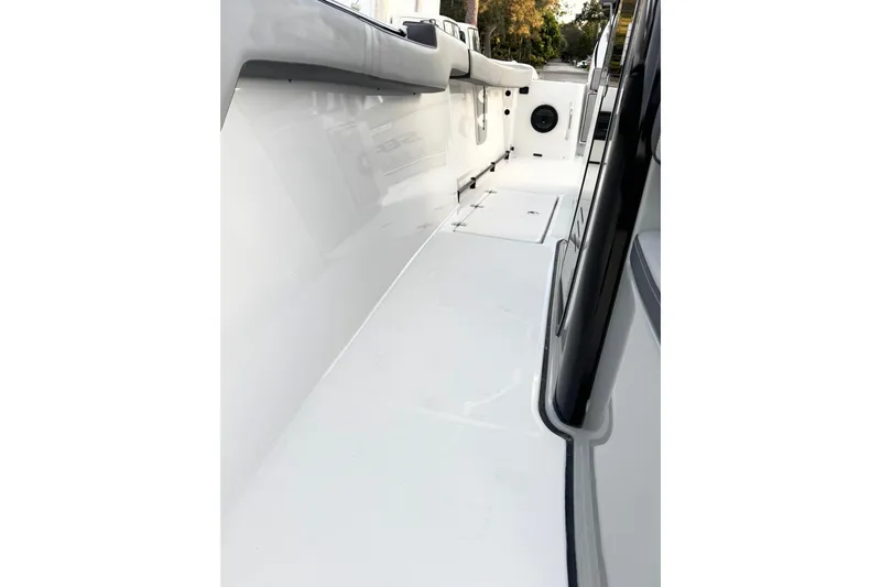  Yacht Photos Pics 2024 Sea Pro 292 DLX boat interior, showcasing sleek white deck and seating.