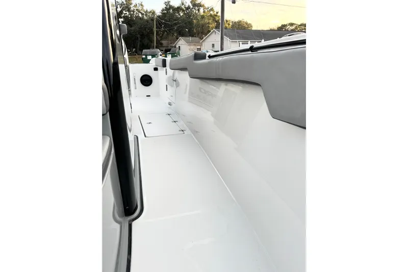  Yacht Photos Pics 2024 Sea Pro 292 DLX boat interior, showcasing sleek white deck and cushioned seating.
