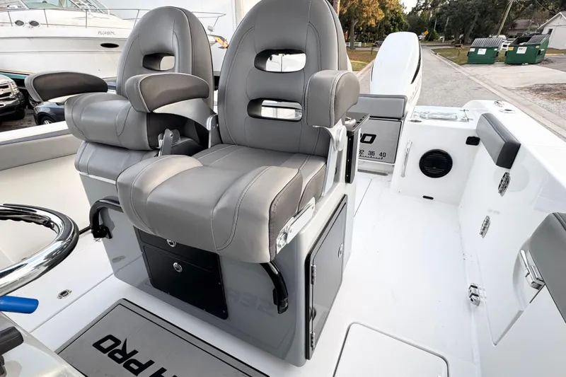  Yacht Photos Pics 2024 Sea Pro 292 DLX boat interior with dual gray captain's chairs and console.