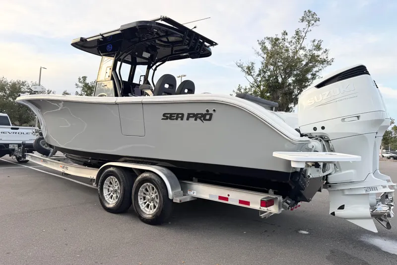  Yacht Photos Pics 2024 Sea Pro 292 DLX boat on trailer with Suzuki outboard motor.