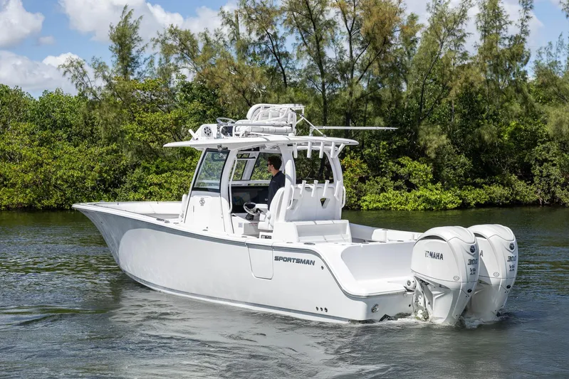  Yacht Photos Pics 2024 Sportsman Open 322 Center Console boat cruising on a scenic waterway.