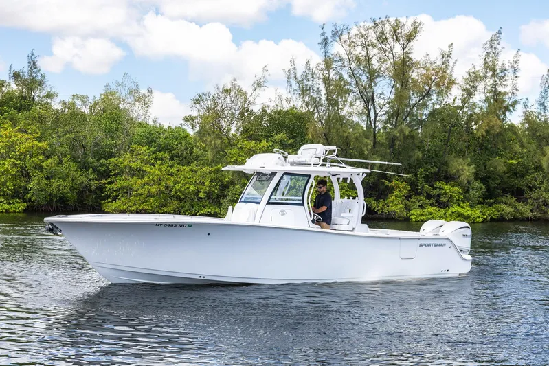  Yacht Photos Pics 2024 Sportsman Open 322 Center Console boat cruising on a calm river.