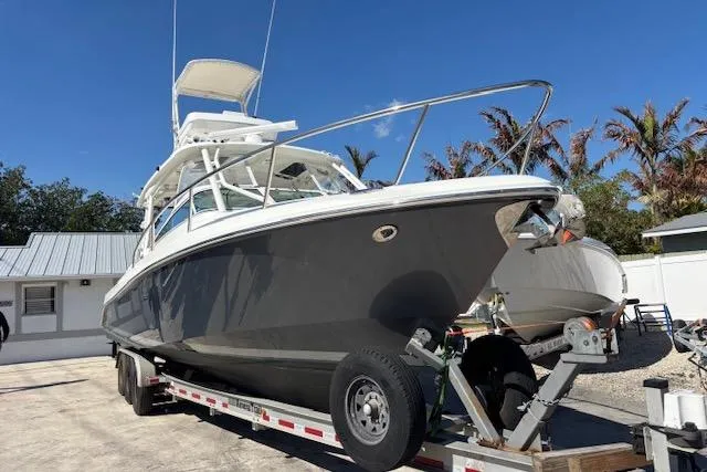  Yacht Photos Pics 2008 Everglades 350LX boat on trailer, parked outdoors under clear blue sky.