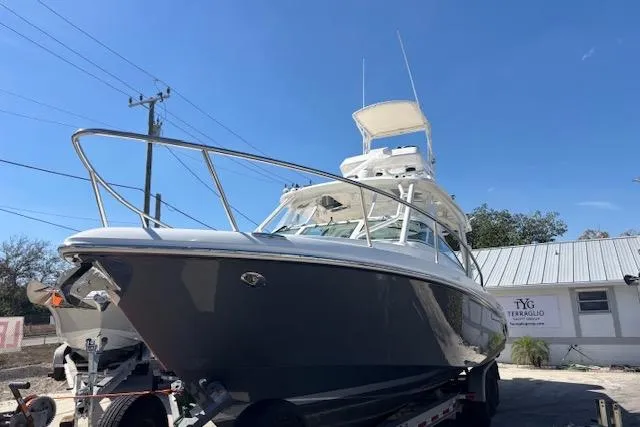  Yacht Photos Pics 2008 Everglades 350LX boat on trailer, parked outdoors under clear blue sky.