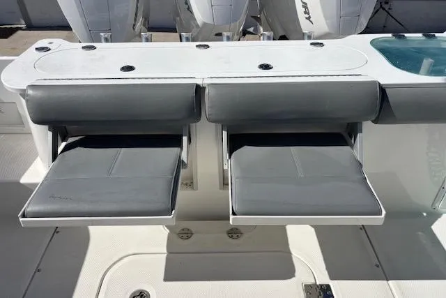  Yacht Photos Pics 2008 Everglades 350LX boat seating area with gray cushions and storage compartments.