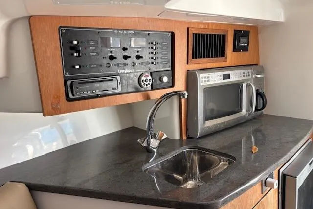  Yacht Photos Pics 2008 Everglades 350LX boat interior with control panel, sink, and microwave.