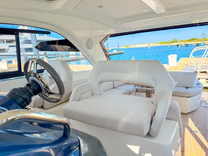  Yacht Photos Pics Interior view of 2021 Beneteau Gran Turismo 41 yacht with plush seating and ocean backdrop.