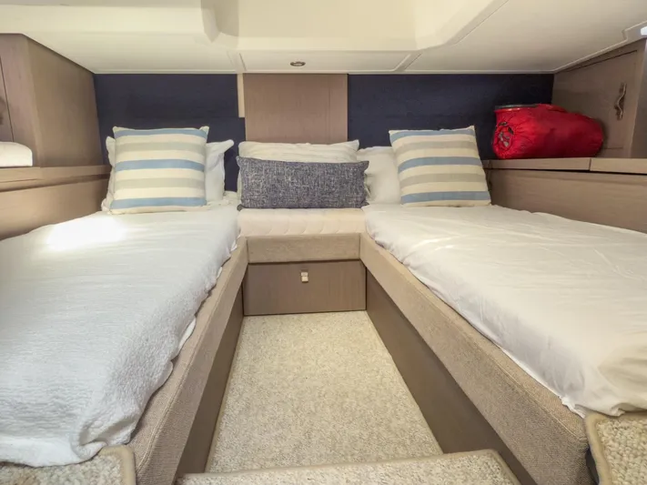  Yacht Photos Pics 2021 Beneteau Gran Turismo 41 cabin with twin beds and striped pillows.