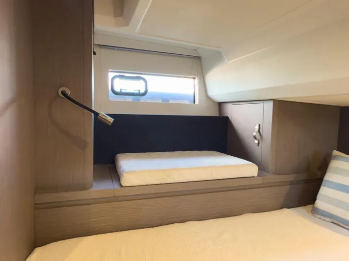  Yacht Photos Pics Interior cabin of 2021 Beneteau Gran Turismo 41 yacht, featuring modern design and cozy bedding.