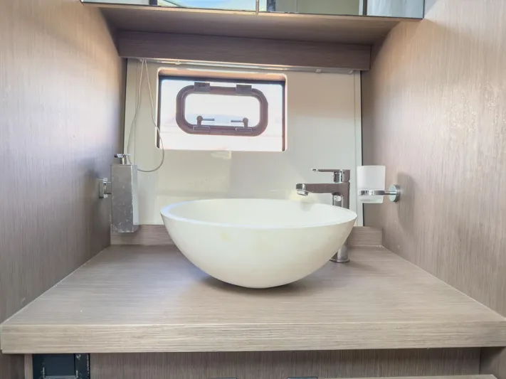  Yacht Photos Pics Modern bathroom sink in 2021 Beneteau Gran Turismo 41 yacht, featuring sleek design and compact space.