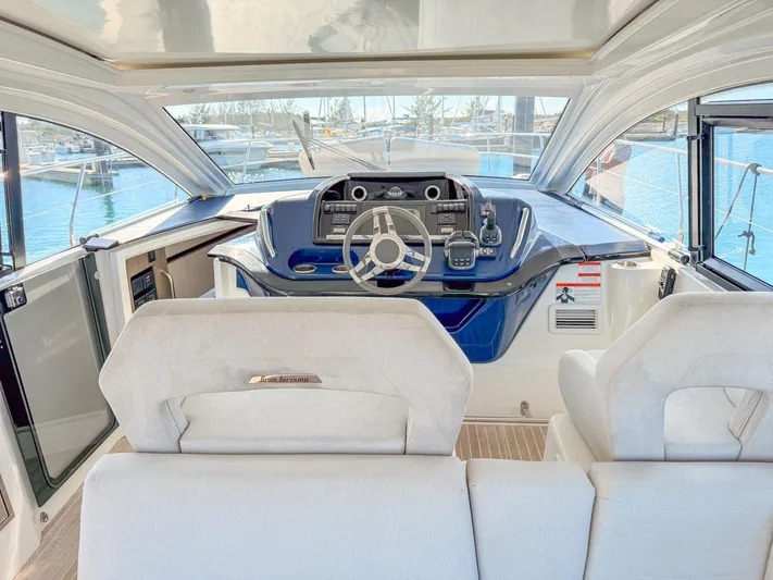  Yacht Photos Pics 2021 Beneteau Gran Turismo 41 yacht interior with modern helm and seating.