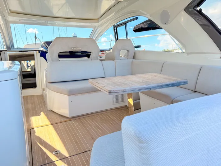  Yacht Photos Pics Luxurious interior of 2021 Beneteau Gran Turismo 41 yacht with plush seating and table.