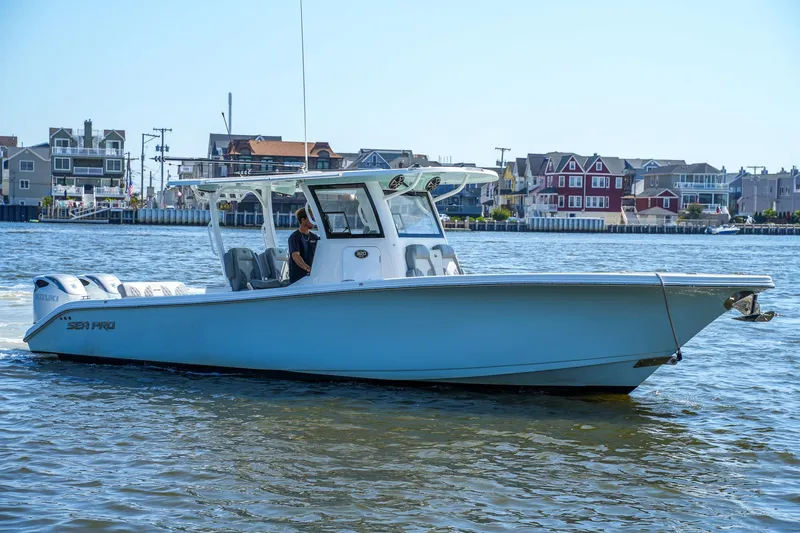  Yacht Photos Pics 2022 Sea Pro 320 DLX Offshore boat cruising near waterfront homes.