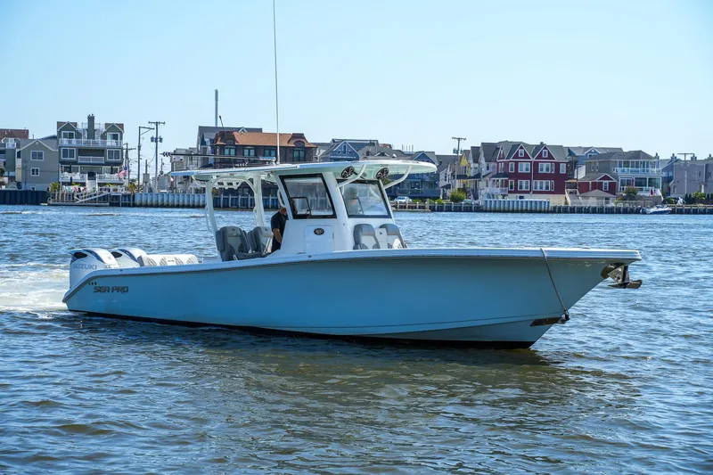  Yacht Photos Pics 2022 Sea Pro 320 DLX Offshore boat cruising near waterfront homes.