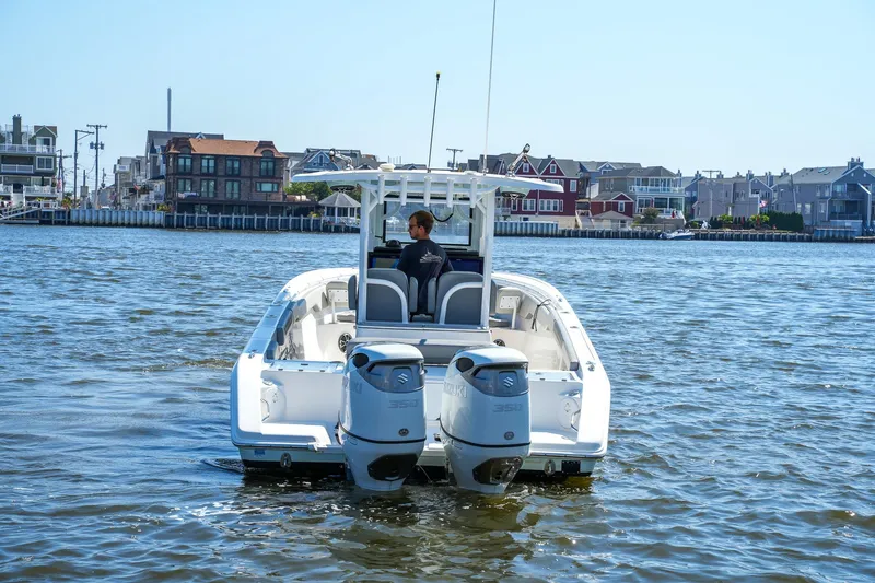  Yacht Photos Pics 2022 Sea Pro 320 DLX Offshore boat cruising near waterfront homes.