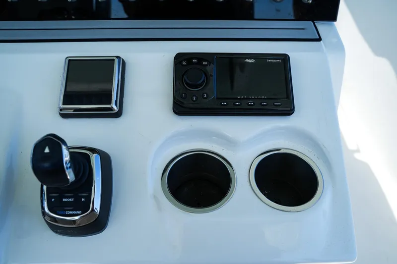  Yacht Photos Pics Control panel of 2022 Sea Pro 320 DLX Offshore boat with joystick and cup holders.