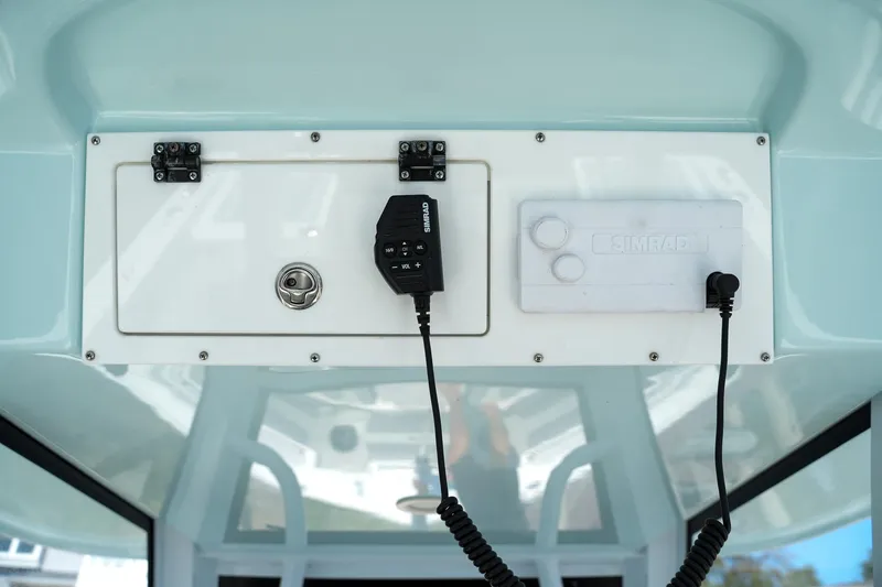  Yacht Photos Pics 2022 Sea Pro 320 DLX Offshore boat console with Simrad electronics and storage compartment.