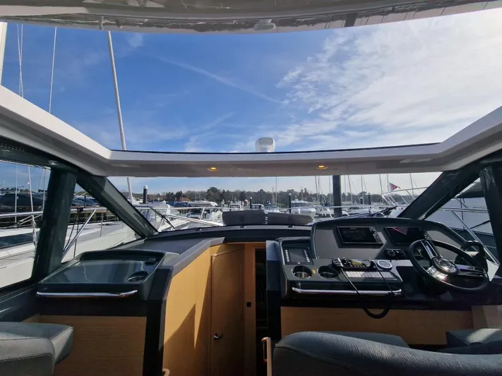 324000084-r40 Yacht Photos Pics Interior view of 2025 Bavaria R40 yacht cockpit with modern navigation equipment and panoramic windows.
