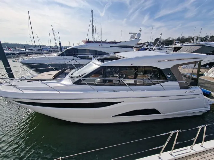 324000084-r40 Yacht Photos Pics 2025 Bavaria R40 yacht docked at marina, sleek design, clear sky background.