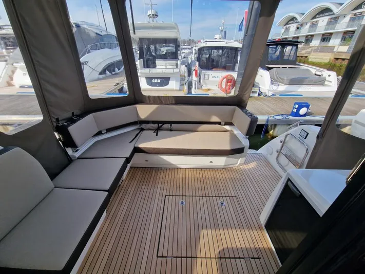 324000084-r40 Yacht Photos Pics Spacious interior of 2025 Bavaria R40 yacht with modern seating and wooden flooring.