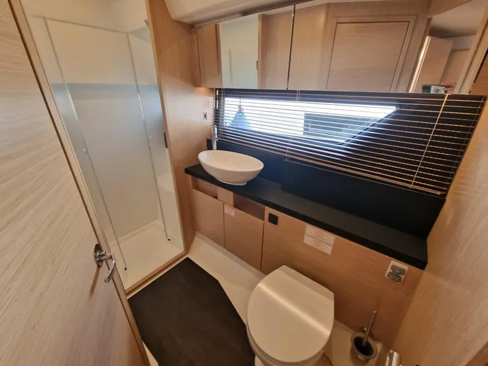 324000084-r40 Yacht Photos Pics Modern bathroom in 2025 Bavaria R40 yacht with shower, sink, and toilet.