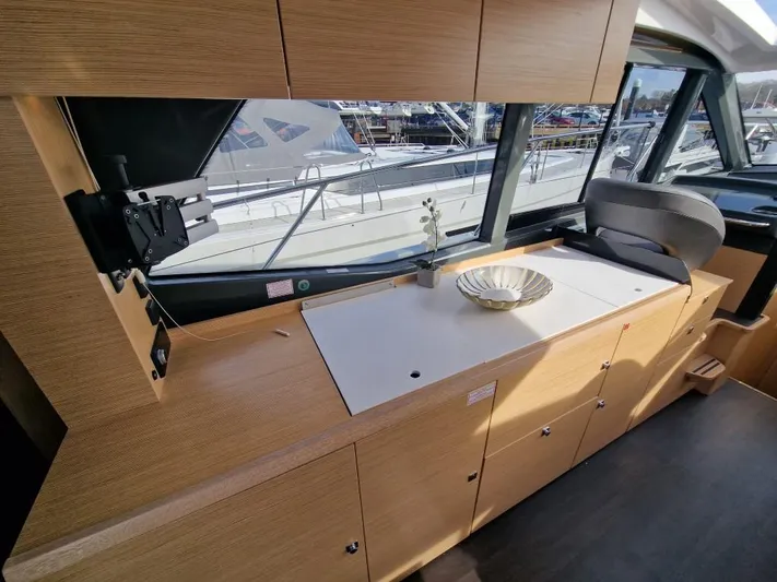 324000084-r40 Yacht Photos Pics Interior of 2025 Bavaria R40 yacht with modern wood cabinetry and large windows.