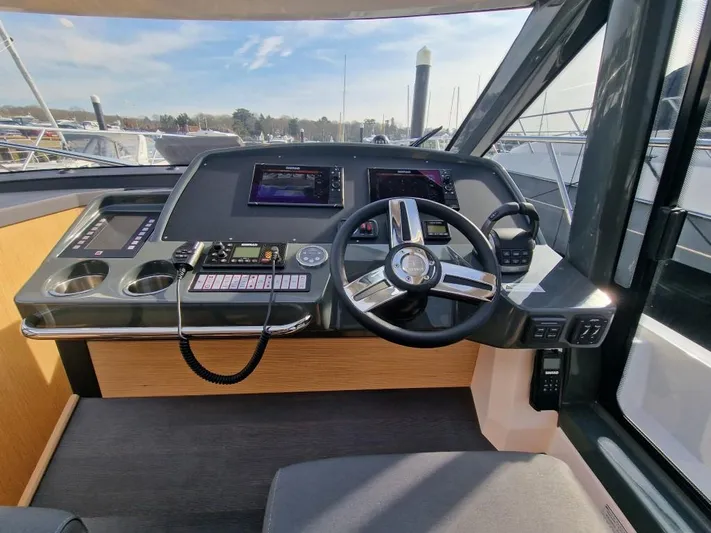 324000084-r40 Yacht Photos Pics Helm of 2025 Bavaria R40 yacht with modern controls and navigation screens.