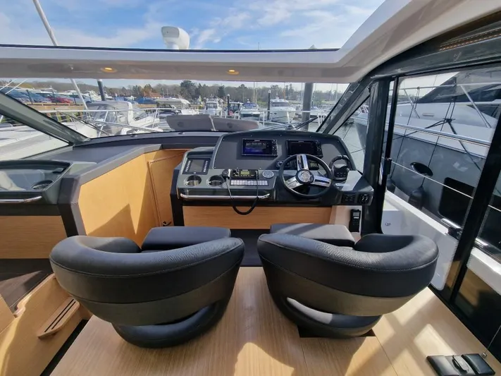 324000084-r40 Yacht Photos Pics Interior of 2025 Bavaria R40 yacht cockpit with modern controls and dual seating.