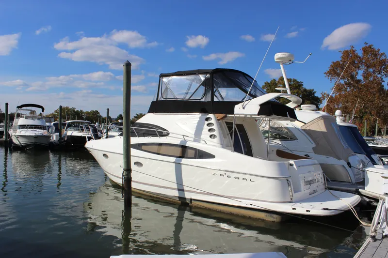  Yacht Photos Pics 2002 Regal Commodore 3880 yacht docked at marina under clear blue sky.