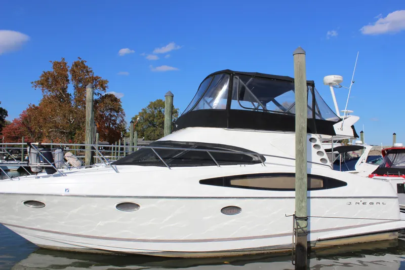  Yacht Photos Pics 2002 Regal Commodore 3880 yacht docked, featuring sleek design and spacious cabin.