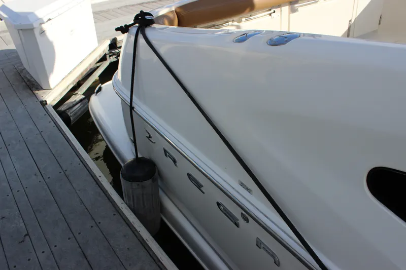  Yacht Photos Pics 2002 Regal Commodore 3880 yacht docked, side view with fender and mooring line.