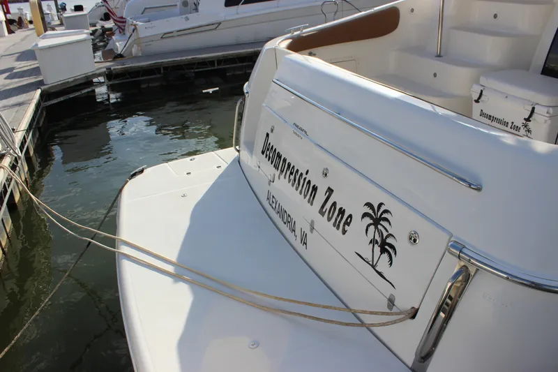  Yacht Photos Pics 2002 Regal Commodore 3880 yacht docked, named "Decompression Zone," with palm tree graphic.