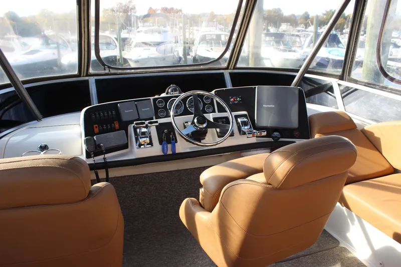  Yacht Photos Pics 2002 Regal Commodore 3880 helm with tan seats and modern navigation equipment.