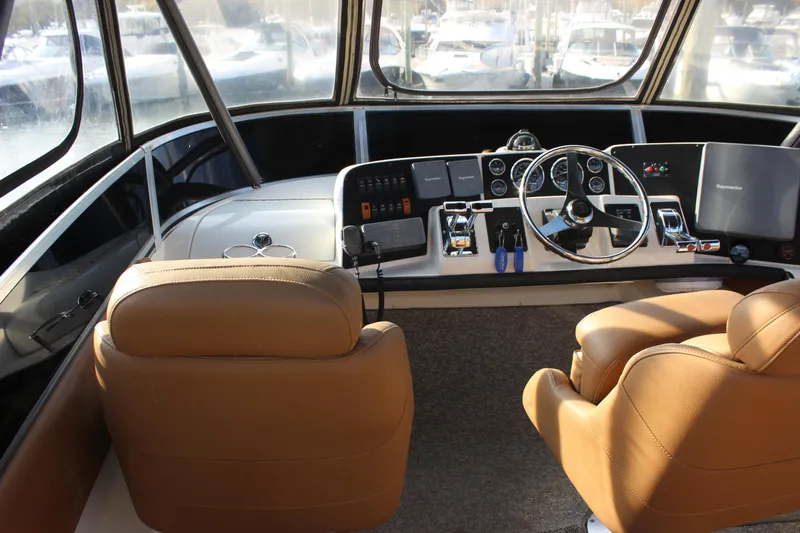  Yacht Photos Pics 2002 Regal Commodore 3880 helm with tan seats and modern controls.