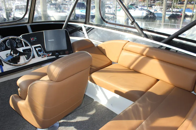  Yacht Photos Pics Interior of 2002 Regal Commodore 3880 yacht with tan leather seating and control panel.