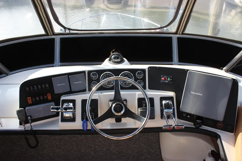 Yacht Photos Pics 2002 Regal Commodore 3880 helm with steering wheel, controls, and navigation equipment.