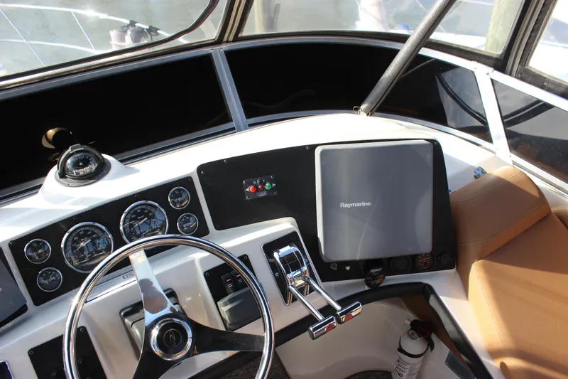  Yacht Photos Pics Cockpit of 2002 Regal Commodore 3880 with steering wheel and navigation instruments.