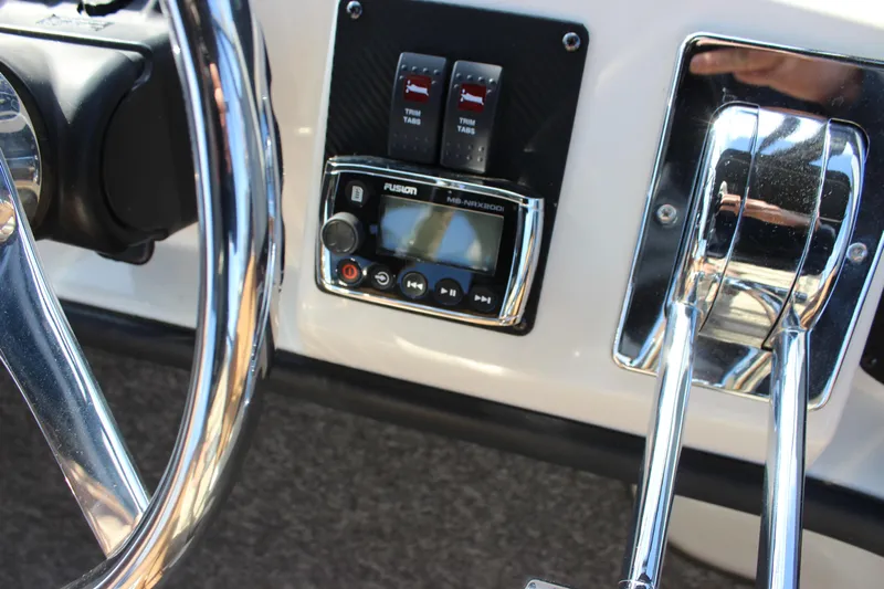  Yacht Photos Pics Steering wheel and controls of 2002 Regal Commodore 3880 boat cockpit.