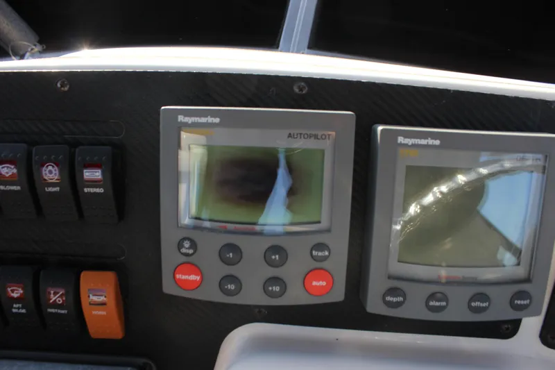  Yacht Photos Pics Control panel of 2002 Regal Commodore 3880 with Raymarine autopilot and depth displays.